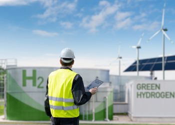 Engineer,With,Tablet,Computer,On,A,Background,Of,Green,Hydrogen