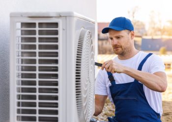 Technician,Working,On,Air,Conditioning,Or,Heat,Pump,Outdoor,Unit.